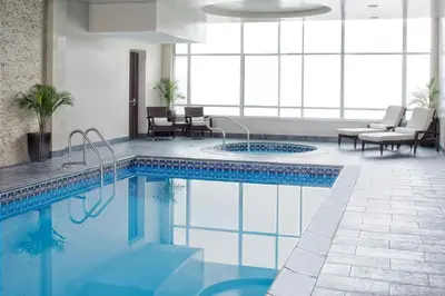 a swimming pool in a room with a table and chairs at The Westin Mount Laurel in Mount Laurel