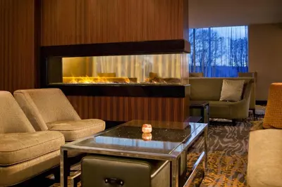 a lobby with a living room with a fireplace at Sheraton Valley Forge King of Prussia in King of Prussia