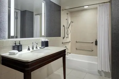 a bathroom with a sink and a tub and a shower at Sheraton Valley Forge King of Prussia in King of Prussia