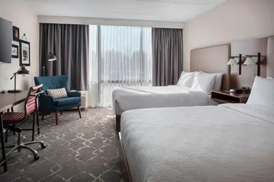 a hotel room with two beds and a desk at Four Points Philadelphia Northeast in Philadelphia