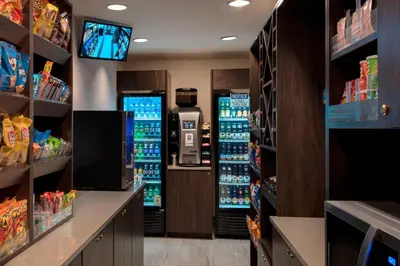 a grocery store aisle with a drink dispenser and vending machines at Four Points Philadelphia Northeast in Philadelphia