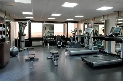 a gym with treadmills and machines in a room at Four Points Philadelphia Northeast in Philadelphia