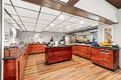 a large kitchen with wooden counter tops in a room at Genetti Hotel, SureStay Collection by Best Western in Williamsport