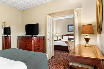 a hotel room with a bed and a television at Genetti Hotel, SureStay Collection by Best Western in Williamsport