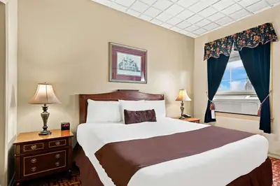 a bedroom with a large bed and a window at Genetti Hotel, SureStay Collection by Best Western in Williamsport