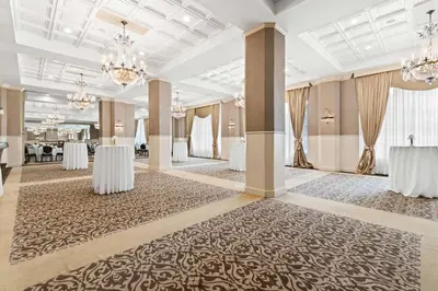 a large banquet hall with tables and chandeliers at Genetti Hotel, SureStay Collection by Best Western in Williamsport