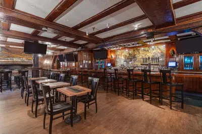 a bar with tables and chairs in a restaurant at Nassau Inn in Princeton