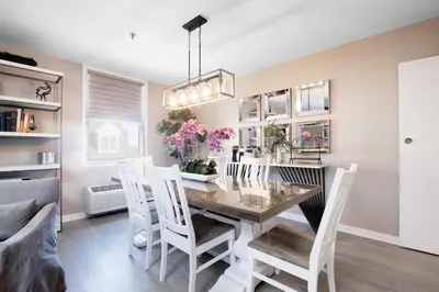 a dining room with a table and white chairs at Nassau Inn in Princeton