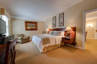 a hotel room with a bed and a television at Nassau Inn in Princeton