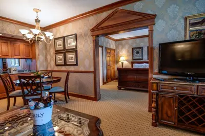 a living room with a television and a dining room at Nassau Inn in Princeton