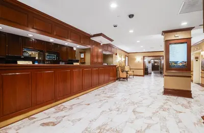 a lobby of a hospital with avertisement for avertisementosateosateosateosatealyses at Nassau Inn in Princeton