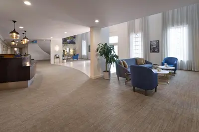 a lobby of a hospital with chairs and a table at Penn Harris Hotel Harrisburg, Trademark by Wyndham in Harrisburg