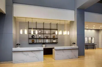 a lobby with a reception desk and a chandelier at Hyatt Regency Morristown in Morristown