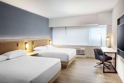 a hotel room with two beds and a chair at Hyatt Regency Morristown in Morristown