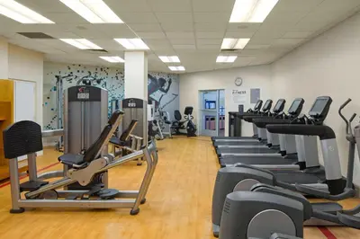 a gym with rows of treadmills and elliptical machines at Sheraton Harrisburg Hershey Hotel in Harrisburg
