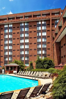 a large building with chairs and a swimming pool at Sheraton Harrisburg Hershey Hotel in Harrisburg