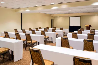 a conference room with tables and chairs and a podium at Sheraton Harrisburg Hershey Hotel in Harrisburg