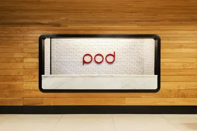 a sign on a wall with two red glasses at Pod 39 in New York