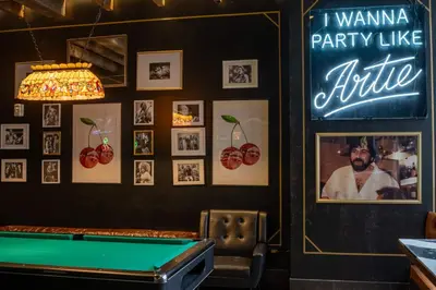 a pool table in a bar with pictures on the wall at Pod 39 in New York