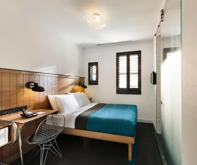 a hotel room with a bed and a desk and a desk at Pod 39 in New York