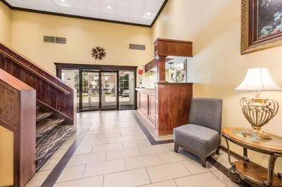 a living room with a table and a chair at Econo Lodge Quakertown in Quakertown