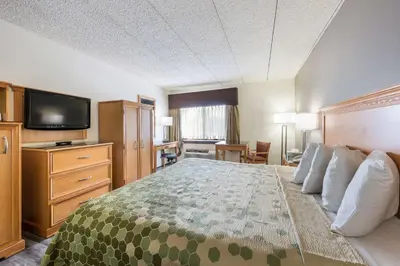 a hotel room with a bed and a flat screen tv at Econo Lodge Quakertown in Quakertown