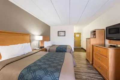 a hotel room with two beds and a flat screen tv at Econo Lodge Quakertown in Quakertown