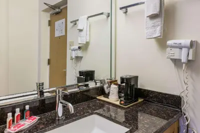 a bathroom with a sink and a mirror at Econo Lodge Quakertown in Quakertown
