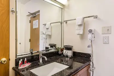 a bathroom with a sink and a mirror at Econo Lodge Quakertown in Quakertown
