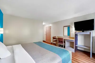 a hotel room with a bed and a desk and a television at Motel 6-Gordonville, PA - Lancaster PA in Gordonville