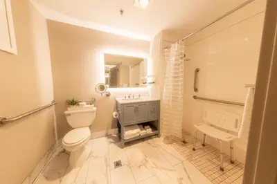 a bathroom with a toilet and a sink and a shower at The Westfield Inn, BW Signature Collection in Westfield