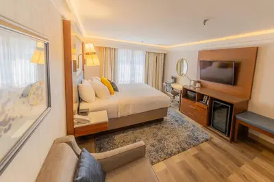 a hotel room with a bed and a television at The Westfield Inn, BW Signature Collection in Westfield
