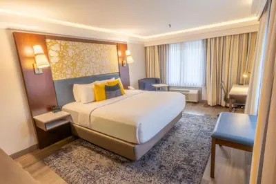 a hotel room with a large bed and a desk at The Westfield Inn, BW Signature Collection in Westfield