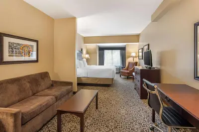 a hotel room with a couch and a bed at Best Western Plus Intercourse Village Inn in Intercourse