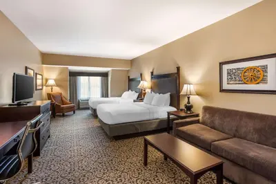 a hotel room with a bed and a couch at Best Western Plus Intercourse Village Inn in Intercourse