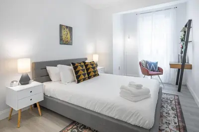 a bedroom with a bed and a desk and a chair at The Cherry Suites - Chinatown in Philadelphia