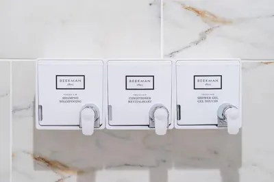 two electrical outlets on a white marble wall at The Cherry Suites - Chinatown in Philadelphia