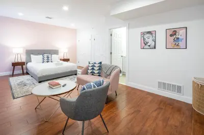 a living room with a bed and a couch and a table at The Cherry Suites - Chinatown in Philadelphia