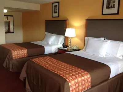 a hotel room with two beds and a lamp at Media Inn & Suites in Media