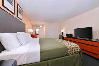 a bedroom with a large bed and a flat screen tv at Media Inn & Suites in Media