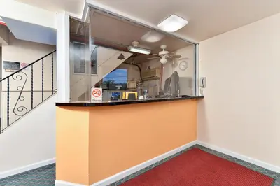 a room with a kitchen with a glass wall at Media Inn & Suites in Media