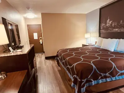 a hotel room with a large bed and a desk at FairBridge Inn Express Nyack in Nyack