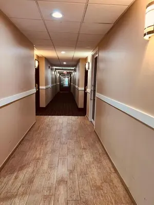 an empty hallway in an office building with a wood floor at FairBridge Inn Express Nyack in Nyack
