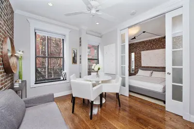 a living room with a table and a bed at APARTMENT NOLITA in New York