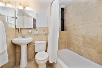 a bathroom with a toilet and a sink and a tub at APARTMENT NOLITA in New York