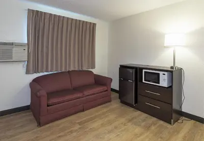 a living room with a couch and a microwave at Red Roof Inn Lancaster Strasburg in Lancaster