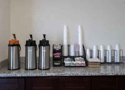 a counter top with two thermos and paper towels at Red Roof Inn Lancaster Strasburg in Lancaster