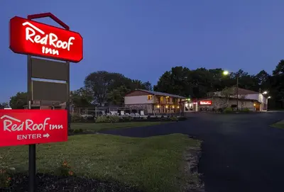 a red raptor sign in front of a restaurant at Red Roof Inn Lancaster Strasburg in Lancaster