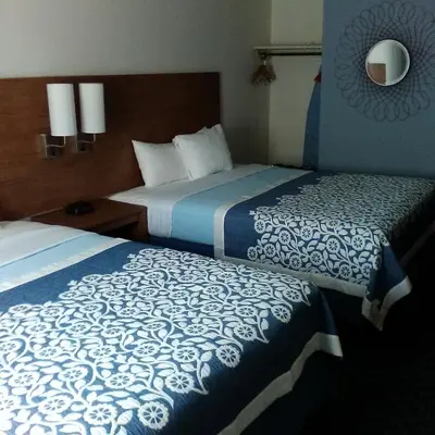 a hotel room with two beds and a mirror at Mainstreet Inn in Doylestown