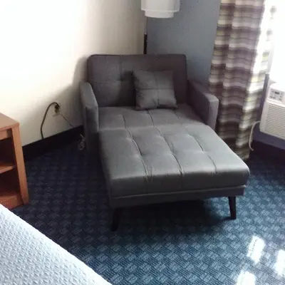 a couch in a room with a bed at Mainstreet Inn in Doylestown